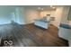 Open-concept kitchen and living area featuring a large island with white cabinets and laminate wood flooring at 3912 Bamboo Branch Dr, Clayton, IN 46118