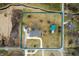 Aerial view showcasing a well-maintained property with house, barn, driveway and landscaping at 3949 W 250 N, Anderson, IN 46011