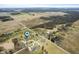 Expansive aerial view of a rural property featuring a well-maintained home and surrounding landscape at 3949 W 250 N, Anderson, IN 46011