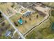 Drone shot showcasing a well-maintained property with house, barn, driveway, landscaping, and a creek at 3949 W 250 N, Anderson, IN 46011