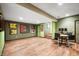 Finished basement area with wood flooring, bar-height table, and unique military-themed decor at 3949 W 250 N, Anderson, IN 46011