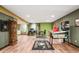 Finished basement with a game area, bar, wood flooring and unique military decor at 3949 W 250 N, Anderson, IN 46011