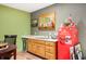 Finished basement bar area with wood cabinets, mini-fridge, and unique decorative items at 3949 W 250 N, Anderson, IN 46011