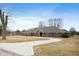 Beautiful single Gathering home with curved driveway and large front yard with bare trees at 3949 W 250 N, Anderson, IN 46011