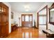 Warm and inviting foyer featuring hardwood floors and a beautiful wooden front door at 3949 W 250 N, Anderson, IN 46011