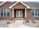 Inviting front porch with brick columns and detailed doorway welcomes you home at 3949 W 250 N, Anderson, IN 46011
