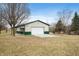 Spacious barn or garage on a property with a large white door and neutral green siding at 3949 W 250 N, Anderson, IN 46011