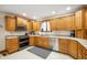 Updated kitchen boasts stainless steel appliances and ample wood cabinet storage at 3949 W 250 N, Anderson, IN 46011