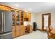 Eat-in kitchen with built-in desk, display cabinets, and backyard views at 3949 W 250 N, Anderson, IN 46011