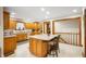 Well-lit kitchen features an island with seating, plenty of counter space, and wooden cabinets at 3949 W 250 N, Anderson, IN 46011