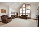 Sun-filled living room has vaulted ceilings, large windows, and comfortable seating at 3949 W 250 N, Anderson, IN 46011