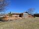 Brick home featuring a backyard with a large deck and sunroom at 4109 E Epler Ave, Indianapolis, IN 46237