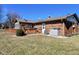 Well-maintained backyard featuring a brick home, wooden deck with hot tub, and a lush lawn for outdoor enjoyment at 4109 E Epler Ave, Indianapolis, IN 46237