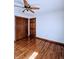 A cozy bedroom featuring hardwood floors, a ceiling fan, and neutral walls at 4109 E Epler Ave, Indianapolis, IN 46237