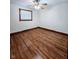 Bedroom with hardwood floors, a window with blinds, and neutral walls at 4109 E Epler Ave, Indianapolis, IN 46237