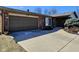 Brick house with two-car garage and wide driveway under a clear blue sky at 4109 E Epler Ave, Indianapolis, IN 46237