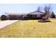 Charming brick home with a well-maintained front lawn and an attached two car garage at 4109 E Epler Ave, Indianapolis, IN 46237