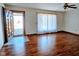 Living room with hardwood floors, a large window, and a ceiling fan at 4109 E Epler Ave, Indianapolis, IN 46237