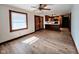 Open-concept living room and kitchen with natural lighting and wood-look flooring at 4109 E Epler Ave, Indianapolis, IN 46237