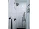 Close up of shower with gray fixtures, subway tile, shower bar, and a detachable head at 4109 E Epler Ave, Indianapolis, IN 46237