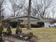 Single-story home with brick facade, well manicured shrubs, and a charming front yard ready for landscaping at 4125 Dequincy St, Indianapolis, IN 46226