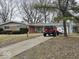 Charming single-story home with a long driveway and a combination brick and siding exterior at 4125 Dequincy St, Indianapolis, IN 46226