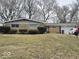 Lovely single-story home featuring a brick facade and attached one car garage, situated on a well maintained lawn at 4125 Dequincy St, Indianapolis, IN 46226