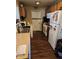 Functional kitchen with wooden cabinetry, essential appliances, and convenient access to the utility area at 4125 Dequincy St, Indianapolis, IN 46226