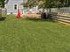 Large, fenced backyard with green grass, wooden deck, outdoor furniture, and shed at 4429 Crittenden Ave, Indianapolis, IN 46205