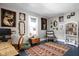 Eclectic bedroom showcasing unique art, comfortable seating, and abundant natural light at 4429 Crittenden Ave, Indianapolis, IN 46205