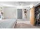 Bright bedroom with a decorative mirror, barn door closet, and a ceiling fan at 4429 Crittenden Ave, Indianapolis, IN 46205