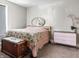 Bedroom with hardwood floors, dresser, mirror, bed, and window with blind at 4429 Crittenden Ave, Indianapolis, IN 46205