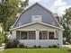 Charming two-story home featuring a covered front porch with painted brick columns and a well-maintained lawn at 4429 Crittenden Ave, Indianapolis, IN 46205
