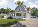 View of the house shows a covered front porch, blue siding, and a well-manicured lawn at 4429 Crittenden Ave, Indianapolis, IN 46205