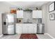 Modern kitchen with stainless steel appliances, white cabinets, and granite countertops at 4429 Crittenden Ave, Indianapolis, IN 46205