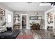 Open living room with modern decor, hardwood floors, and seamless flow to other areas of the home at 4429 Crittenden Ave, Indianapolis, IN 46205