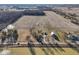 Aerial view of the blue house, surrounding property including barn, and vast farmland landscape at 4844 N 700 W, McCordsville, IN 46055
