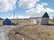 Aerial view of property featuring a blue shed and a barn, set on a farm under a partly cloudy sky at 4844 N 700 W, McCordsville, IN 46055