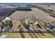 Expansive aerial view of a farmhouse, barn, and land, showcasing the property's setting and potential at 4844 N 700 W, McCordsville, IN 46055