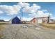 Spacious barn and outbuilding on a large lot with beautiful blue sky and white clouds at 4844 N 700 W, McCordsville, IN 46055