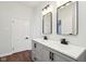 Stylish bathroom featuring a double vanity, black fixtures, and wood look flooring at 4844 N 700 W, McCordsville, IN 46055