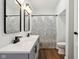 Modern bathroom featuring double vanity with black fixtures and wood look flooring at 4844 N 700 W, McCordsville, IN 46055