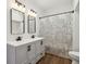 Modern bathroom featuring double vanity with black fixtures and wood look flooring at 4844 N 700 W, McCordsville, IN 46055