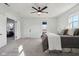 Bedroom with grey carpet, ceiling fan, window, and view to living room at 4844 N 700 W, McCordsville, IN 46055