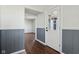 Bright entryway with wainscoting, hardwood floors, and a charming paneled front door providing a warm welcome at 4844 N 700 W, McCordsville, IN 46055