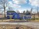Charming blue farmhouse with a welcoming porch and well-maintained landscaping on a sunny day at 4844 N 700 W, McCordsville, IN 46055