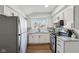 Bright kitchen with white cabinets and modern stainless steel appliances at 4844 N 700 W, McCordsville, IN 46055