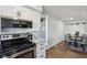 Open kitchenette view with black appliances and white cabinets at 4844 N 700 W, McCordsville, IN 46055