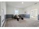Bright and cozy living room with soft carpet, wainscoting, and natural light, perfect for relaxing and entertaining at 4844 N 700 W, McCordsville, IN 46055