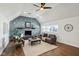 Living room featuring stone fireplace, three windows, vaulted ceiling and wood floors at 4844 N 700 W, McCordsville, IN 46055